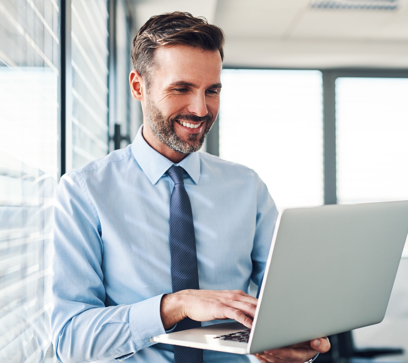 a man sitting in front of a laptop