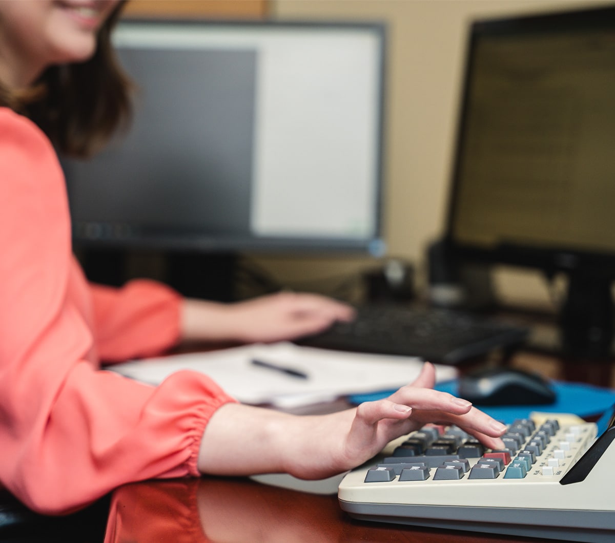 a woman sitting at a table using a laptop computer